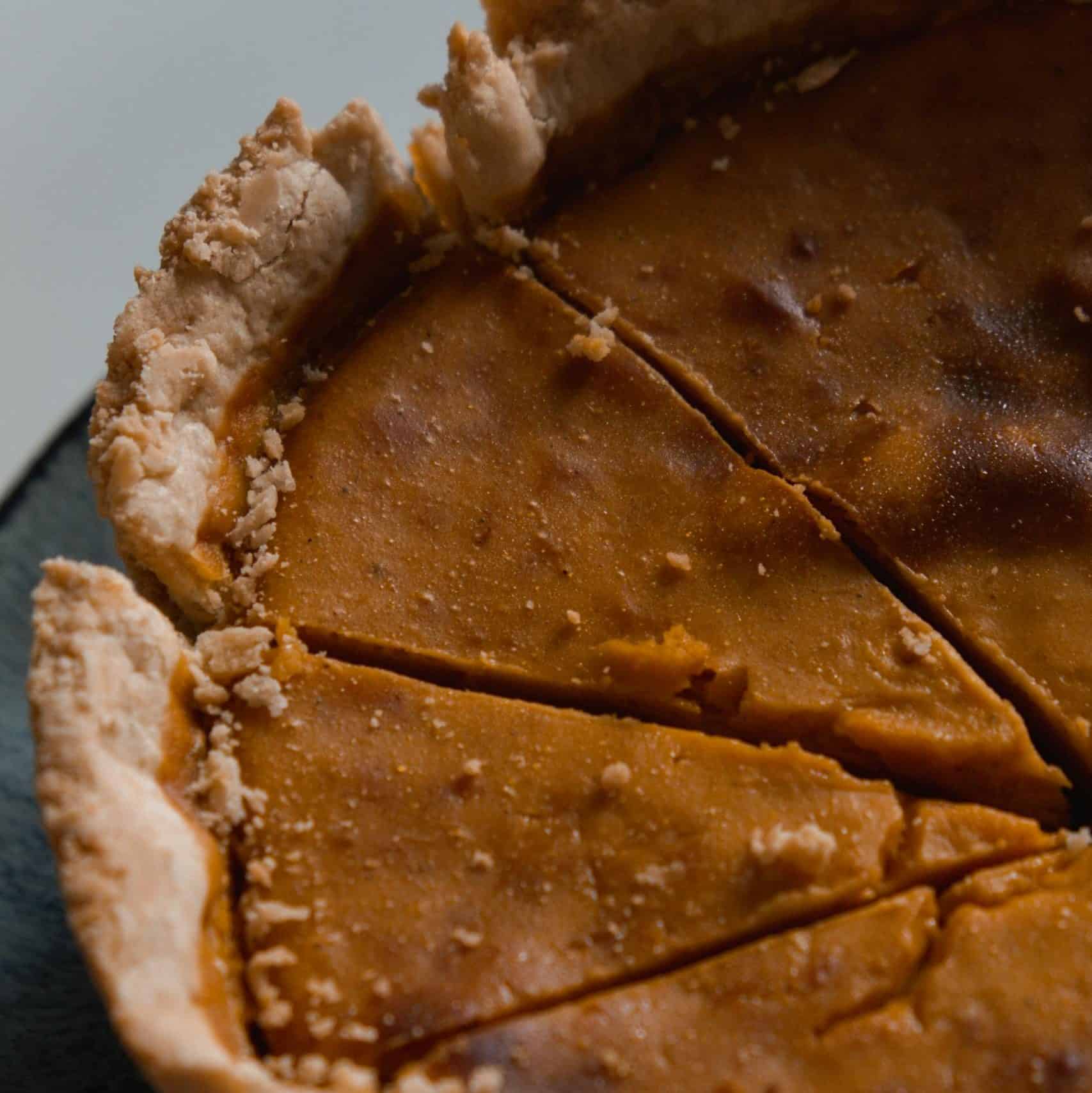Appetizing close-up of a sliced homemade pumpkin pie, perfect for fall desserts.