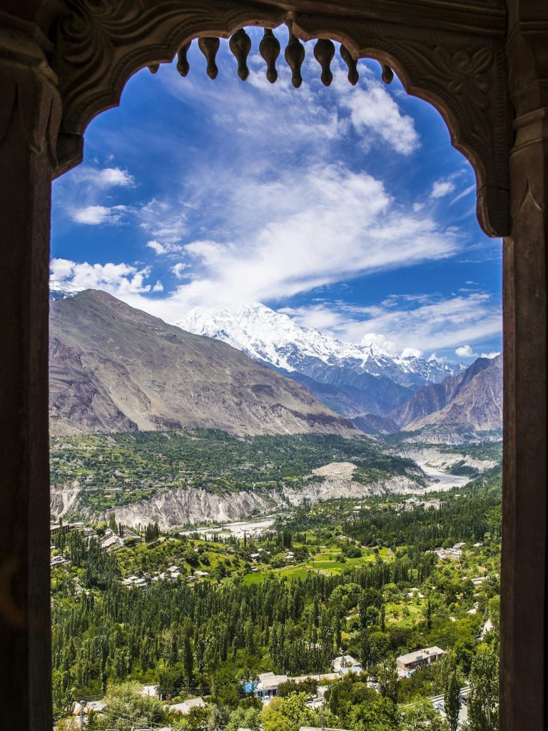 Breathtaking view of Hunza Valley and mountains framed by Altit Fort architecture.