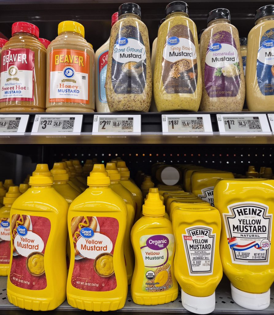 variety of mustards on a grocery store shelf